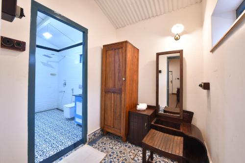 a bathroom with a sink and a mirror at The Hearth in Kodaikānāl