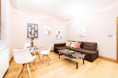 a living room with a couch and a table at [St.Paul's Cathedral] Modern Apartment City of London in London