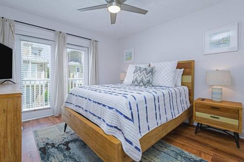 a bedroom with a bed and a ceiling fan at * Sugar Sands * Steps to Beach * Pool * Balconies * in Panama City Beach
