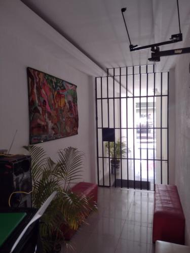 a living room with a couch and a painting on the wall at Pousada Trilha do Pelo in Salvador