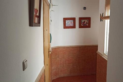 a bathroom with a brick wall and a window at APARTAMENTO SANTA MARÍA in Cádiz