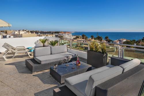 a patio with couches and a view of the ocean at Apartamento Michel Sea View Algarve in Albufeira