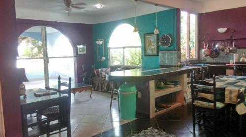 a kitchen with a counter and a table in a room at Agave-Blue in Bacalar