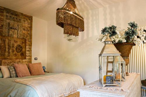 a bedroom with a bed and a chandelier at Casa Salvia in Garda