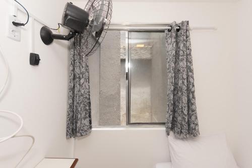 a bathroom with a shower curtain and a window at Apto Bela Vista São Paulo in Sao Paulo