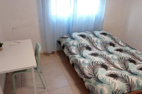 a couch sitting in a room next to a table at One bedroom private apartment - quiet near a park in Beer Sheva