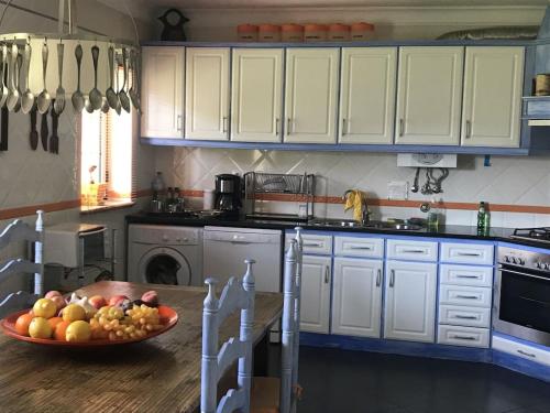 a kitchen with a bowl of fruit on a table at Baleal, by the sea with swimming pool in Baleal
