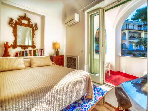 a bedroom with a bed and a large window at Villa Silia in Capri