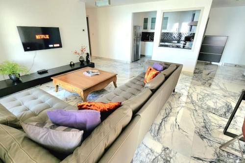 a living room with a couch and a table at Luxury Sea View Beachfront 3 Bedroom Apt, JBR in Dubai