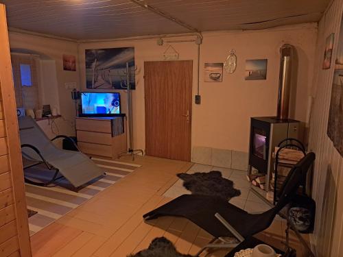 a living room with a television and a table and chairs at Apartment Schloffer in Weiz