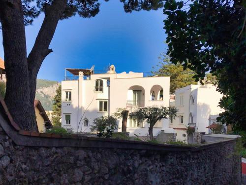 a white house with trees in front of it at Villa Silia in Capri