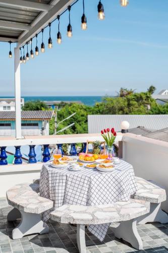 a table with plates of food on a balcony at Beach Block No.5 at Huahin Beach in Hua Hin
