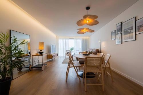 a living room with a dining table and a living room at Island Retreat Apt (city center) in Ponta Delgada