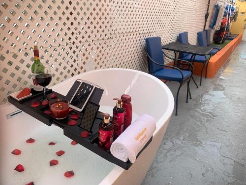 a bath tub with a table with a bottle of wine at Levittown Lakes in Levittown