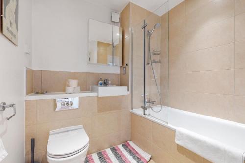 a bathroom with a toilet and a shower and a sink at Lovely 1 bed apartment in Streatham in London