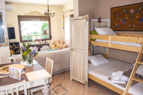 a room with two bunk beds and a table at Sofia's House in Paleo Tsifliki