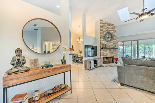 a living room with a mirror and a couch at Pet-Friendly Central Florida Home with Pool! in Lake Mary