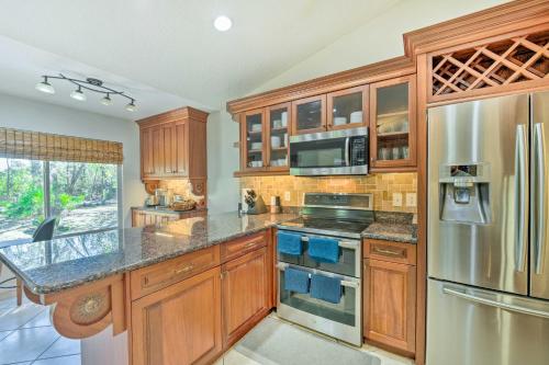 a kitchen with wooden cabinets and a stainless steel refrigerator at Walk to Lake Stunning Central Florida Home! in Lake Mary