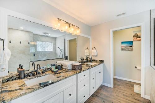 a bathroom with two sinks and a large mirror at Pet-Friendly Central Florida Home with Pool! in Lake Mary