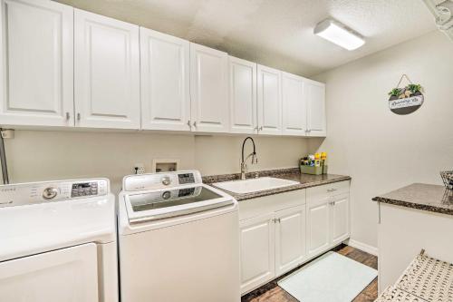 a kitchen with white cabinets and a sink at Walk to Lake Stunning Central Florida Home! in Lake Mary