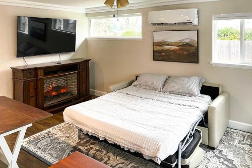 a bedroom with a bed and a tv and a fireplace at Well-Appointed Milwaukie Home Great Location in Milwaukie