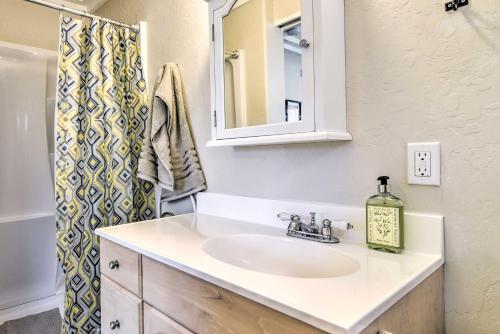 a bathroom with a sink and a mirror at Well-Appointed Milwaukie Home Great Location in Milwaukie