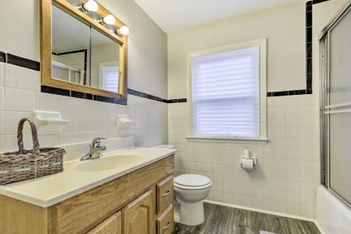 a bathroom with a sink and a toilet and a mirror at Charming Hamden Home 2 Mi to Yale University in Hamden