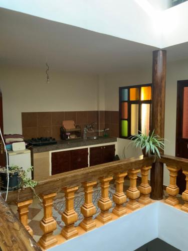 a kitchen with a wooden railing in a room at House Naïma in Rabat
