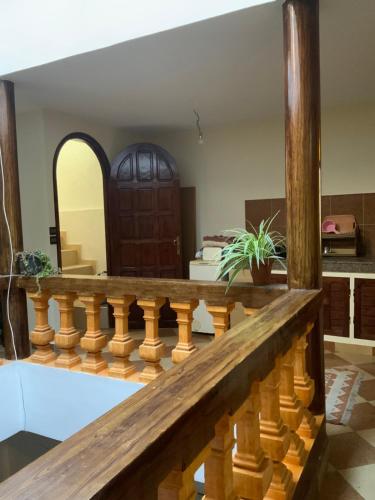 a wooden staircase in a living room with a wooden door at House Naïma in Rabat