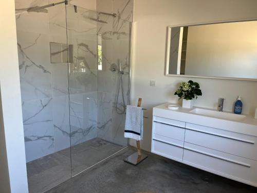 a bathroom with a shower and a sink and a mirror at Monte Casa Branca in Montemor-o-Novo