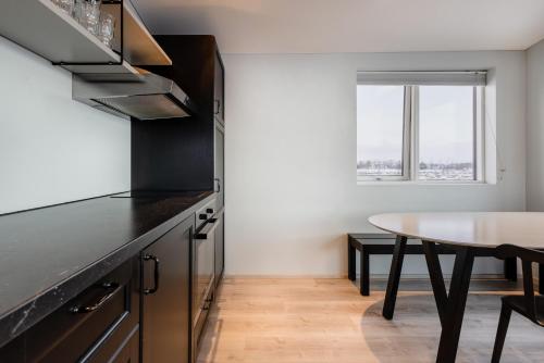 a kitchen with a table and a dining room at Gotta Cottages in Selfoss