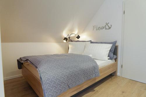 1 dormitorio con 1 cama con un cartel en la pared en Exklusives Ferienapartment in der Papenburger Stadtmitte, en Papenburg