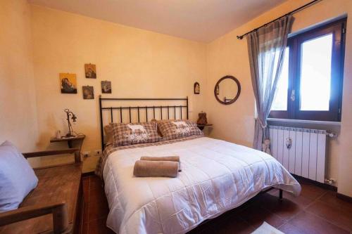 a bedroom with a large bed and a window at Maison Bruno in Pescocostanzo