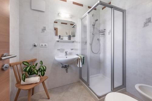 a bathroom with a shower and a sink at Apartments Schönblick in Mühlbach