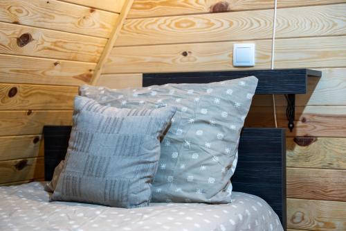 a bed with a pillow and a head board at Vila Deniri in Zlatibor