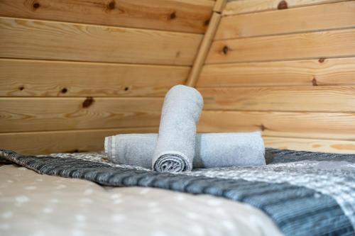 a roll of toilet paper sitting on top of a bed at Vila Deniri in Zlatibor