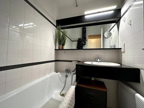 a bathroom with a sink and a bath tub at Appartement vue Port Bourgenay, emplacement idéal in Talmont