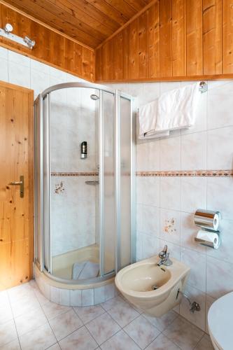 a bathroom with a shower and a sink at Residence Innerfarmerhof in Tirolo