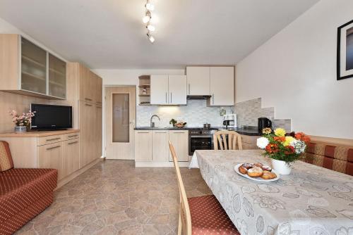 a kitchen with a table with a plate of food on it at Apartments Schönblick in Mühlbach