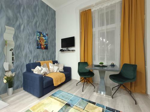 a living room with a blue couch and a table at Suzan's apartment in the heart of Budapest in Budapest