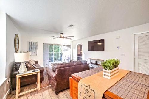 a living room with a couch and a table at Walk-In Condo Amenities, 3 Mi to Branson Landing! in Branson