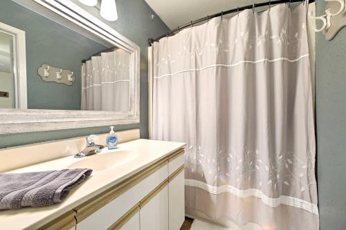 a bathroom with a sink and a shower curtain at Walk-In Condo Amenities, 3 Mi to Branson Landing! in Branson
