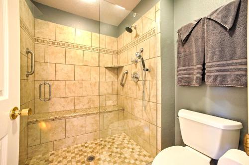 a bathroom with a shower and a toilet at Walk-In Condo Amenities, 3 Mi to Branson Landing! in Branson