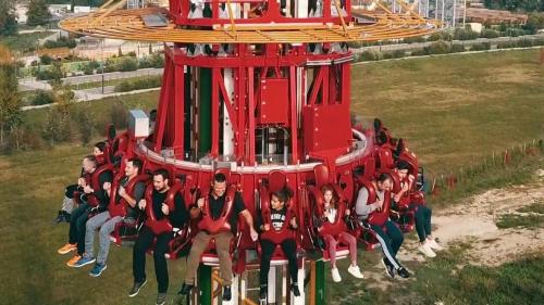 a group of people sitting on a roller coaster at Provence, Studio climatisé, vue lac Spirou 400 metres, Avignon 15 mn in Monteux