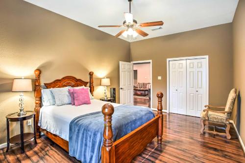 a bedroom with a bed and a ceiling fan at Texas Vacation Rental with Fireplace, Near Lakes in Marshall