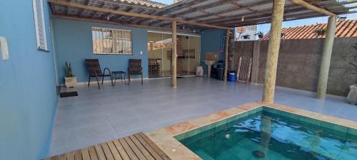 a house with a swimming pool and a patio at Edicula Brotas in Brotas