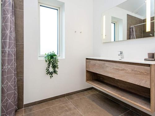 a bathroom with a sink and a mirror at Holiday home Rømø CXXV in Sønderby