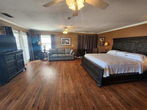 a bedroom with a bed and a couch and a tv at Tennessee Room at Tennessee RiverPlace in Chattanooga
