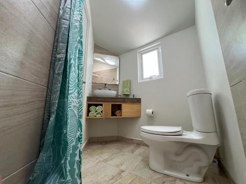 a small bathroom with a toilet and a sink at Privada 400 in Pachuca de Soto