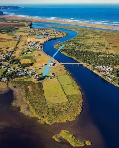 an aerial view of a body of water next to a beach at Cucao Chiloe in Chonchi